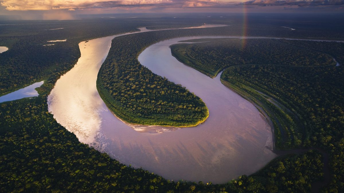 Aerial view of Madre de Dios River winding through Amazonian rain forest. (Theo Allofs/ Corbis Documentary)