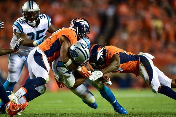 Quarterback Cam Newton #1 of the Carolina Panthers is hit by free safety Bradley Roby #29 and middle linebackerTodd Davis #51 of the Denver Broncos as he rushes at Sports Authority Field at Mile High on September 8, 2016 in Denver, Colorado. (Photo by Dustin Bradford/Getty Images)
