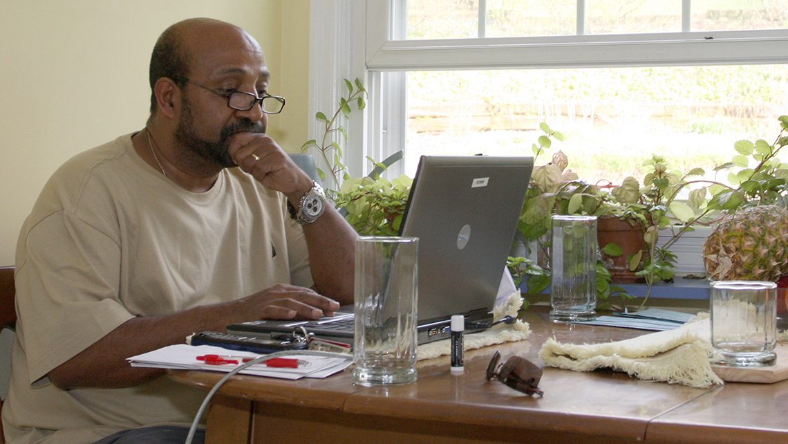 Dr. Berhanu Nega works on his computer in the kitchen of his house in Lewisburg, Pa., Saturday, April 25, 2009. The Ethiopian government has arrested 35 people suspected of a coup attempt allegedly backed by Nega, an Ethiopian economist now teaching at a Pennsylvania university, a government spokesman said Saturday. (AP Photo/John Zeedick)