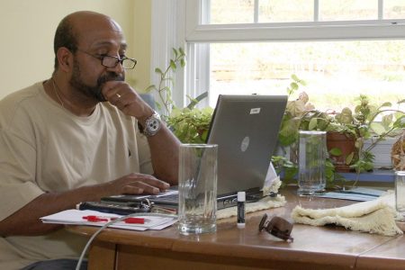 Dr. Berhanu Nega works on his computer in the kitchen of his house in Lewisburg, Pa., Saturday, April 25, 2009. The Ethiopian government has arrested 35 people suspected of a coup attempt allegedly backed by Nega, an Ethiopian economist now teaching at a Pennsylvania university, a government spokesman said Saturday. (AP Photo/John Zeedick)