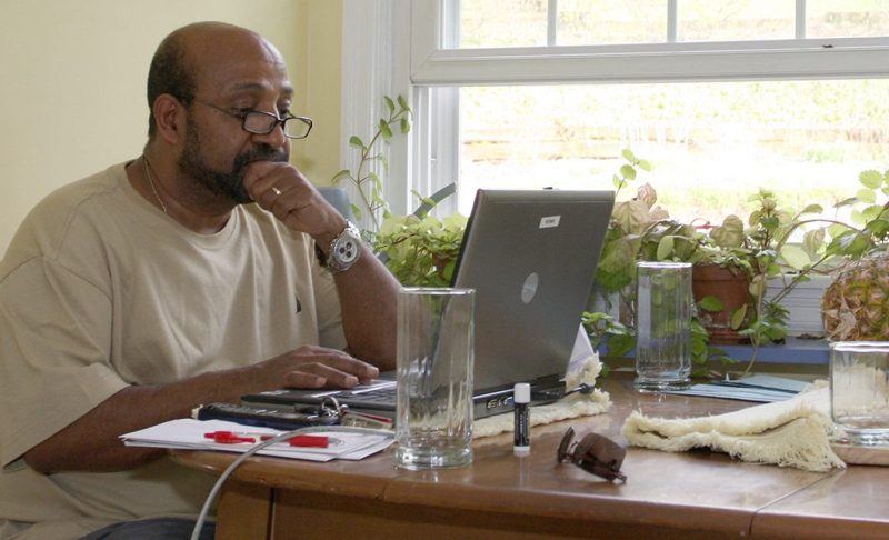 Dr. Berhanu Nega works on his computer in the kitchen of his house in Lewisburg, Pa., Saturday, April 25, 2009. The Ethiopian government has arrested 35 people suspected of a coup attempt allegedly backed by Nega, an Ethiopian economist now teaching at a Pennsylvania university, a government spokesman said Saturday. (AP Photo/John Zeedick)