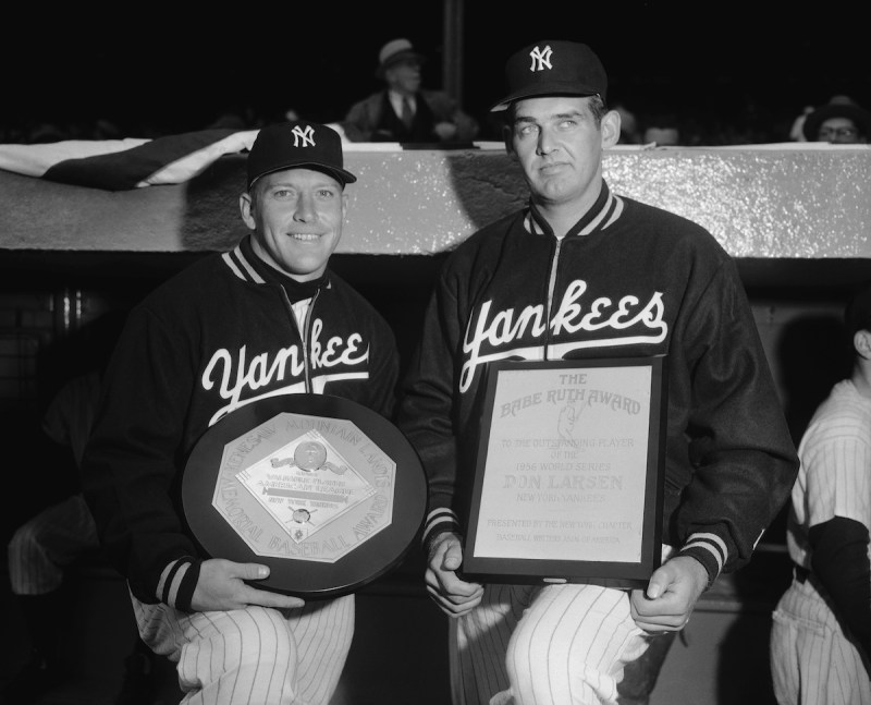(Original Caption) Mickey Mantle, left, star center fielder of the New York Yankees and pitcher Don Larsen, also of the Yankees, are shown holding their awards they received before the opening day game at the Yankee Stadium today. Mickey is holding the Most Valuable Player award he won last year when he captured the Triple Crown of Baseball. Larsen displays his Babe Ruth award he received for his outstanding achievement in the World Series for pitching a perfect game against the Dodgers.