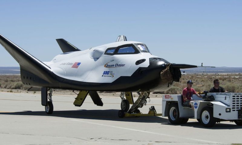 In this June 27, 2013 photo provided by NASA, Sierra Nevada Corp. engineers and technicians prepare the Dream Chaser engineering test vehicle for tow tests at NASA's Dryden Flight Research Center in California. On Thursday, Jan. 14, 2016, NASA announced the Sierra Nevada Corp. will join SpaceX and Orbital ATK in launching cargo to the International Space Station. These flights, yet to be finalized, will run through 2024. (Ken Ulbrich/NASA via AP)