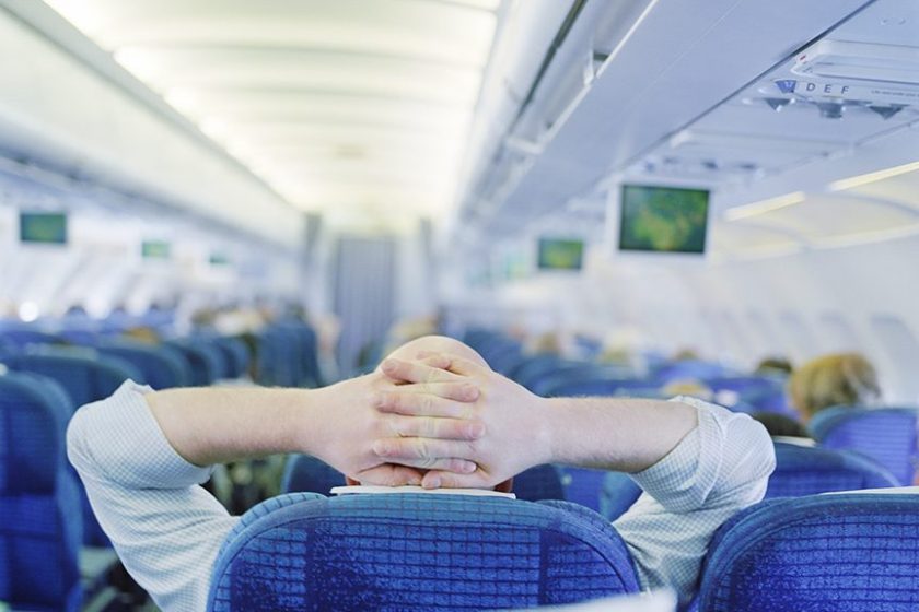 Man relaxing in an airplane (Getty Images)