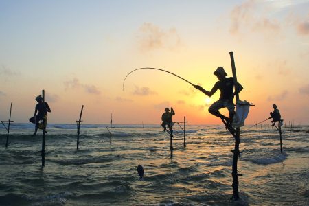 Sri Lankan stilt fishermen at sunset on the south coast. (Paul Kennedy/Lonely Planet Images/ Getty Images)