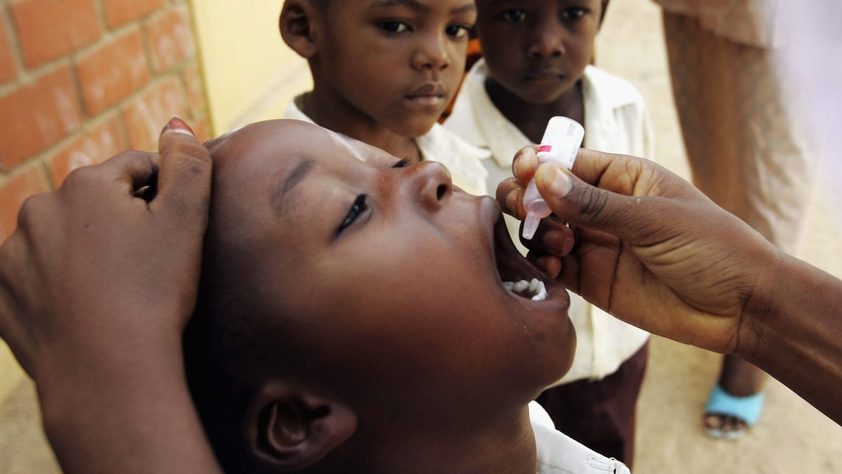 A Nigerian schoolboy is vaccinated against polio during a mass nationwide polio inoculation April 12, 2005, in Kano, Nigeria. (Chris Hondros/Getty Images)