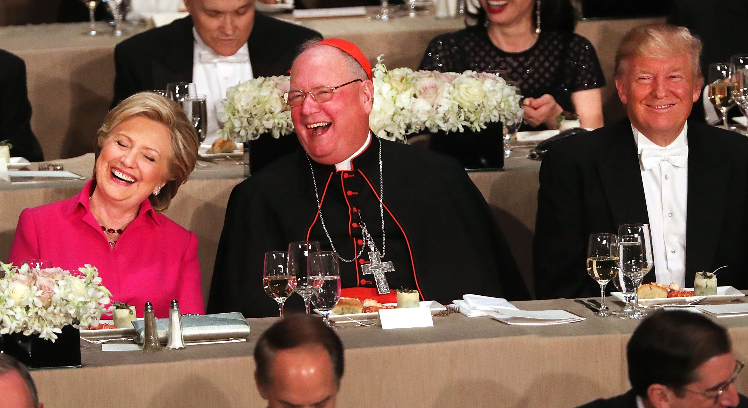 Cardinal Timothy Dolan sits between, Hillary Clinton and Donald Trump attend the annual Alfred E. Smith Memorial Foundation Dinner at the Waldorf Astoria on October 20, 2016 in New York City.The white-tie dinner, which benefits Catholic charities and celebrates former Governor of New York Al Smith, has been attended by presidential candidates since 1960 and gives the candidates an opportunity to poke fun at themselves and each other. (Spencer Platt/Getty Images)