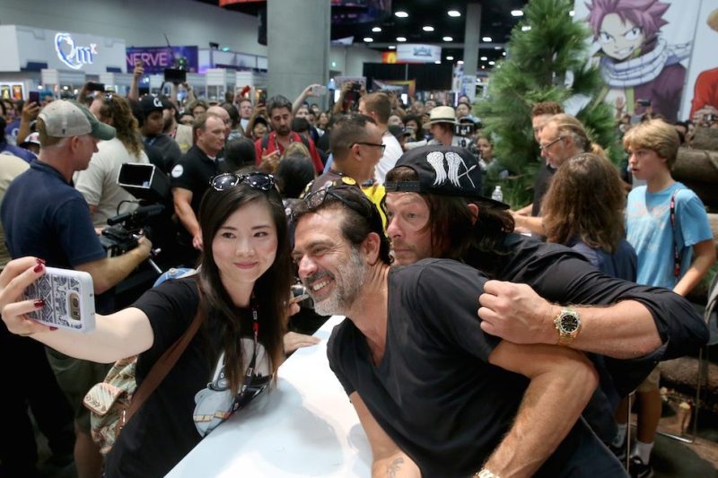 SAN DIEGO, CA - JULY 22: (L-R) Actors Jeffrey Dean Morgan and Norman Reedus pose for a selfie with a fan at AMC's 'The Walking Dead' autograph signing during Comic-Con International 2016 at San Diego Convention Center on July 22, 2016 in San Diego, California. (Photo by Jesse Grant/Getty Images for AMC)