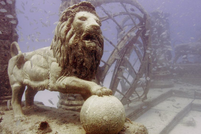 Fish swim near a lion sculpture in the Neptune Memorial Reef Tuesday, April 29, 2008, 3.25 miles off the coast of Key Biscayne, Fla. Creators of the reef hope it will become a memorial for the dead and a diving site. Instead of a burial funeral, people can pay to have their remains placed in one the reef's structures after their death. (AP Photo/Wilfredo Lee)