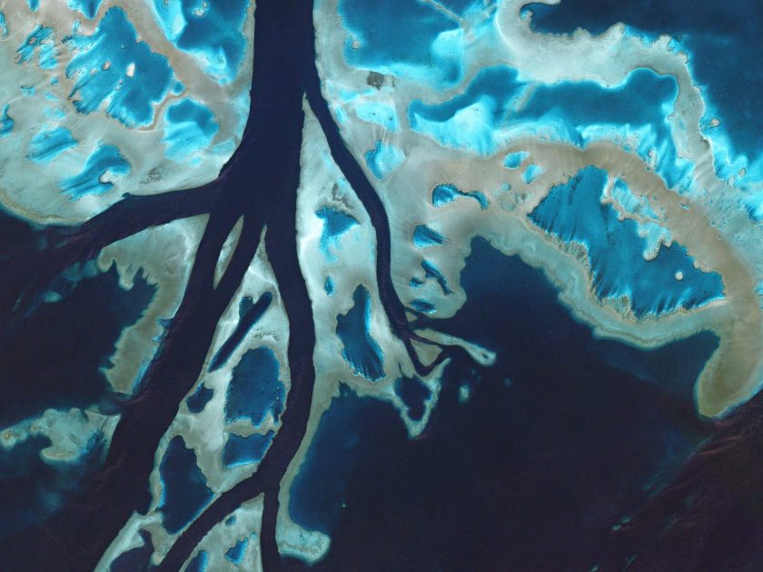 Taken on July 7, 2016, tidal channels cut through unnamed reefs off the coast of Queensland. These corals are part of the enormous Great Barrier Reef, which stretches for 1,400 miles along the coast of mainland Australia in the Coral Sea. (Courtesy Planet Labs)