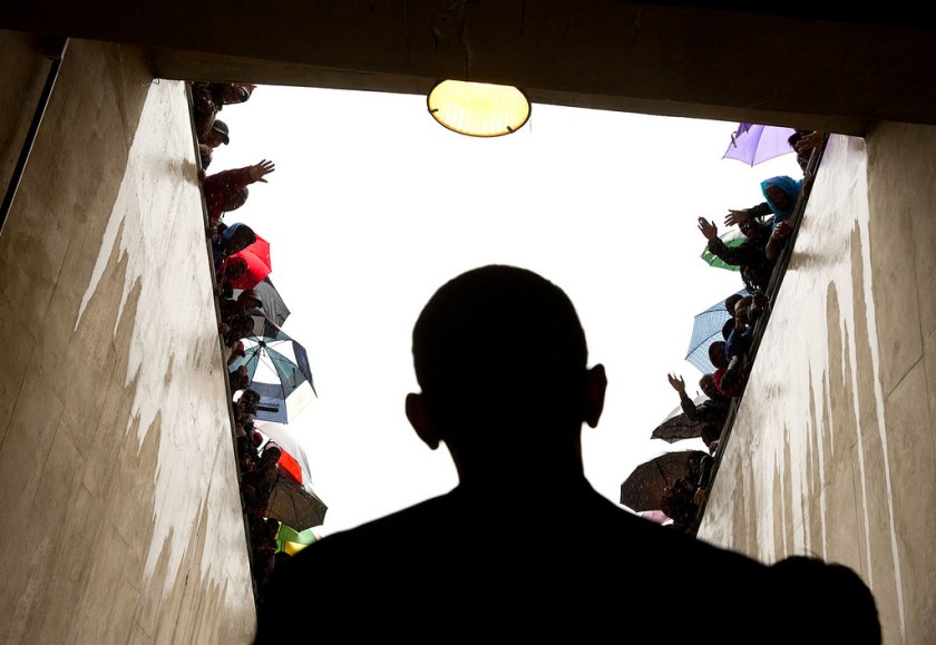 "South Africans cheer as President Obama waits in a tunnel at the soccer stadium before taking the stage to speak at Nelson Mandela's memorial service. It was a long overnight flight to Johannesburg, a few hours on the ground in the pouring rain, and then a long flight back to Washington." (Official White House Photo by Pete Souza)