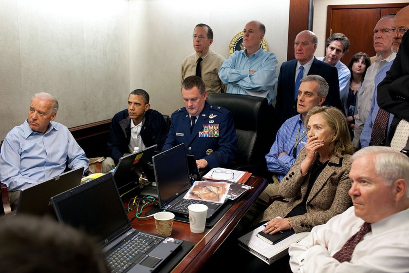 President Barack Obama and Vice President Joe Biden, along with members of the national security team, receive an update on the mission against Osama bin Laden in the Situation Room of the White House, May 1, 2011. Seated, from left, are: Brigadier General Marshall B. “Brad” Webb, Assistant Commanding General, Joint Special Operations Command; Deputy National Security Advisor Denis McDonough; Secretary of State Hillary Rodham Clinton; and Secretary of Defense Robert Gates. Standing, from left, are: Admiral Mike Mullen, Chairman of the Joint Chiefs of Staff; National Security Advisor Tom Donilon; Chief of Staff Bill Daley; Tony Blinken, National Security Advisor to the Vice President; Audrey Tomason Director for Counterterrorism; John Brennan, Assistant to the President for Homeland Security and Counterterrorism; and Director of National Intelligence James Clapper. Please note: a classified document seen in this photograph has been obscured. (Official White House Photo by Pete Souza) 