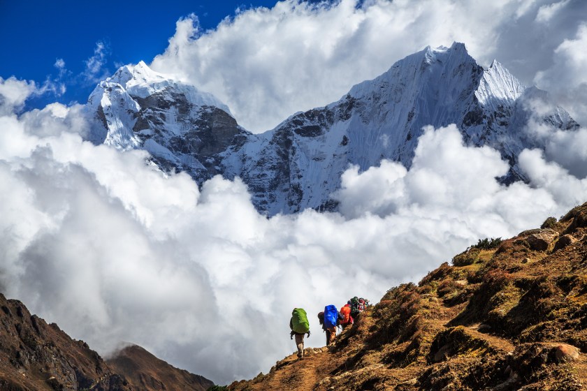 A group of trekker on the popular Gokyo Ri trekking route ineastern Nepal with majestic Himalaya mountains, Khangtega and Thamserku, in the background. (Getty Images)