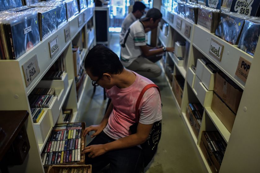 This picture taken on October 8, 2016 shows collectors browsing through audio cassettes during "International Cassette Store Day" in Subang Jaya, on the outskirts of Kuala Lumpur. (Mohd Rasfan/AFP/Getty Images)