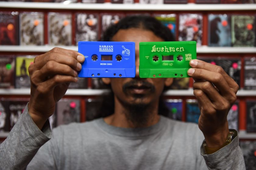 This picture taken on October 4, 2016 shows Mohamad Nor Yaacob, co-founder of Malaysia's Basement Records, which focuses on hardcore punk and metal, posing with colourful used audio cassettes in Kuala Lumpur. (Mohd Rasfan/AFP/Getty Images)