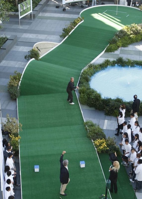 PGA Tour profesional Fred Couples raises his arms but fails to make a hole in one at a minigolf course on the plaza at LA Live on Novmber 11, 2010. An urban golf event involved sixth grade math students in Teach For America from Stephenson Middle School in E. Los Angeles and the students were rewarded for their hard work in mathematics with the funfilled golf experience. The event celebrates the upcoming Chevron World Challenge, a PGA Tour cosponsored event and the World Challenge features 18 of the world's best golfers and benefits educationfocused nonprofits. If Couples made the hole in one, then Chevron would have donated $15,000 to the education nonprofit partners. LA Live plaza was transformed on Thursday (one day only) into a picturesque urban minigolf oasis complete wth a 9hole course, sand trap, pro shop and clubhouse. Couples also gave golf pointers to the students.  (Photo by Gary Friedman/Los Angeles Times via Getty Images)