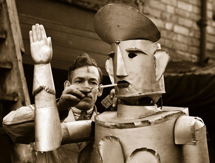 An electrical engineer lights his robot's cigarette in 1939. (Fox Photos/Getty Images)