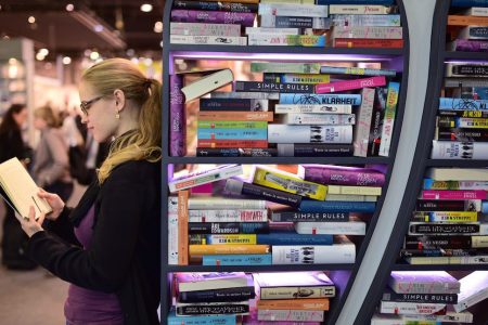 FRANKFURT AM MAIN, GERMANY - OCTOBER 15:  A woman reads a book at the 2015 Frankfurt Book Fair (Frankfurter Buchmesse) on October 15, 2015 in Frankfurt am Main, Germany. The 2015 fair, which is among the world's largest book fairs, will be open to the public from October 13-18.  (Photo by Thomas Lohnes/Getty Images)