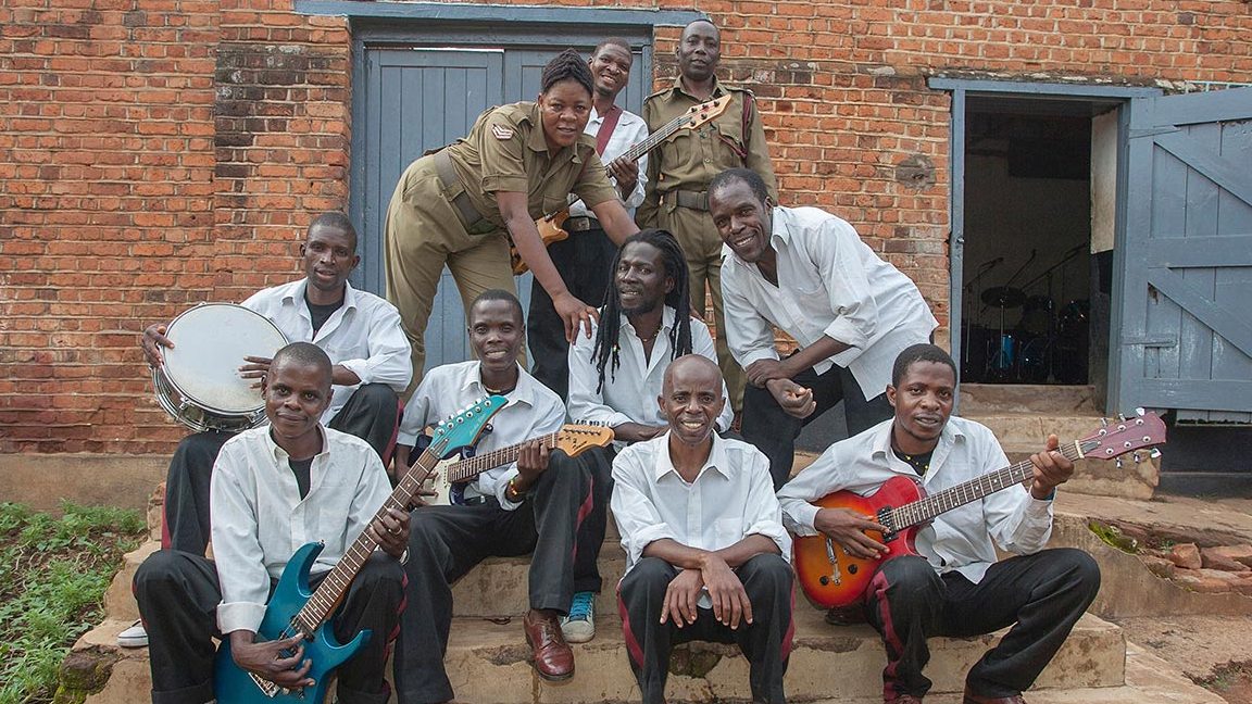 Members of Malawi's Zomba Prison Project band pose for a photograph outside the Central Prisons makeshift music studio at the end of a rehearsal on January 8, 2016 in Zomba, Malawi. (AMOS GUMULIRA/AFP/Getty Images)