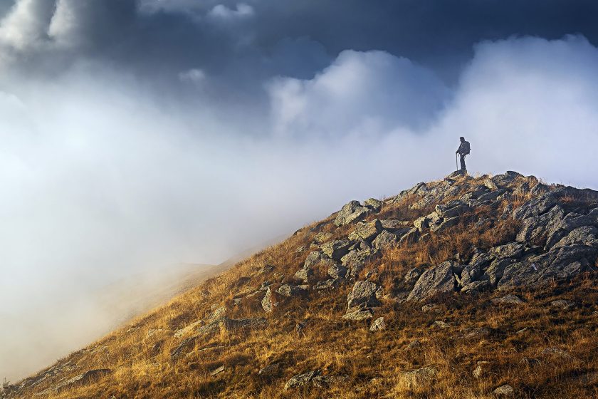 A hiker stands on the peak of Matorac in the Dinaric Alps of central Bosnia and Herzegovina, along a section of the Balkans’ 1,200-mile Via Dinarica trail. (Courtesy National Geographic Traveler)