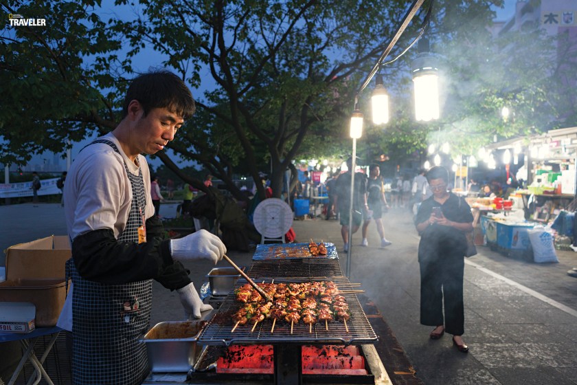 Chicken skewers grilling at a sidewalk stall in Yeouido Park. (Courtesy National Geographic Traveler)