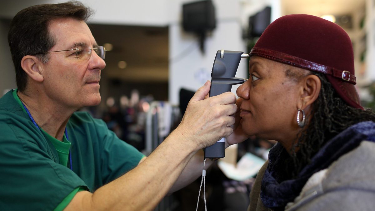 Mary Sanders (R) has her eyes examined by a Remote Area Medical (RAM) volunteer optometrist John Weis during a free clinic held at the Oakland-Alameda County Coliseum on April 11, 2011 in Oakland, California. (Justin Sullivan/Getty Images)