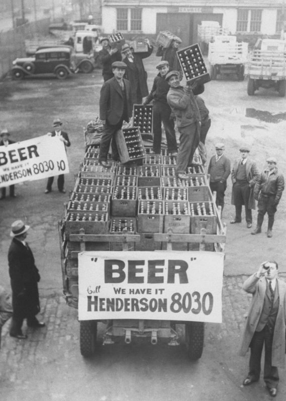 Men atop beer delivery truck hoist cases of beer triumphantly while man standing in front of truck drinks out of beer bottle following the repeal of Prohibition.  (Time Life Pictures/National Archives/The LIFE Picture Collection/Getty Images)