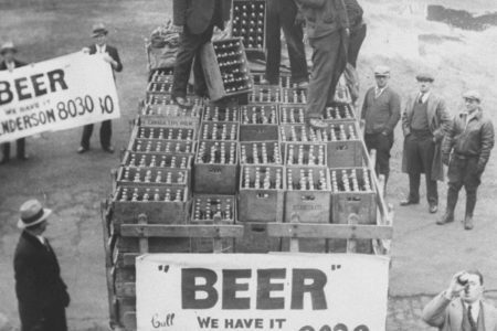 Men atop beer delivery truck hoist cases of beer triumphantly while man standing in front of truck drinks out of beer bottle following the repeal of Prohibition.  (Time Life Pictures/National Archives/The LIFE Picture Collection/Getty Images)