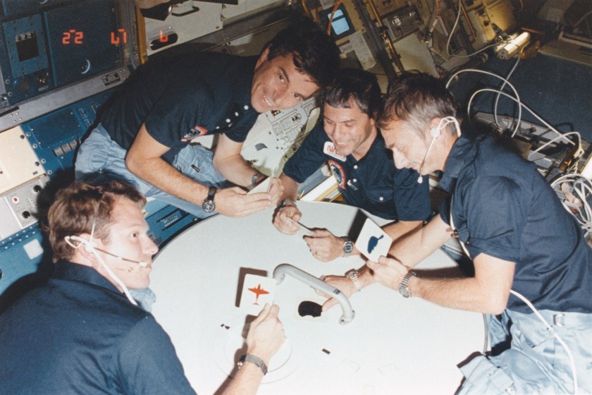 What appears to be a space card game is actually just four STS-9 crew enjoying a rare brief moment of collective fun inside the Spacelab module on board the Earth 'orbiting' Columbia. (Getty Images)