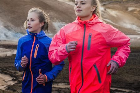 Friends running on mountain road in Iceland. (Portra Images/Getty Images)