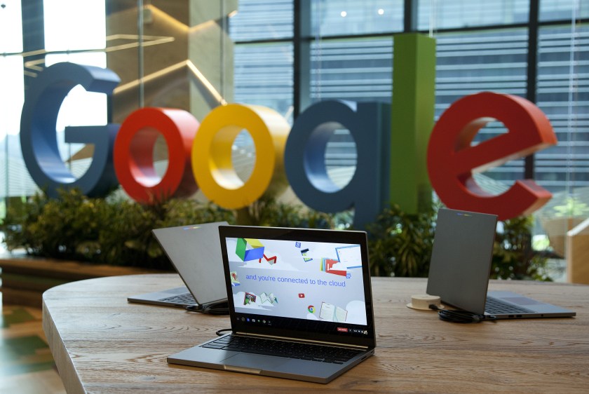 Google Inc. Chromebook laptop computers sit on display in front of a sign featuring the company's logo at the company's Asia-Pacific headquarters during its opening day in Singapore, on Thursday, Nov. 10, 2016. (Ore Huiying/Bloomberg via Getty Images)