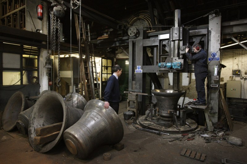 A bell tuner at the Whitechapel Bell Foundry uses an industrial lathe to tune a bell destined for the church of St Magnus (Oli Scarff/Getty Images)