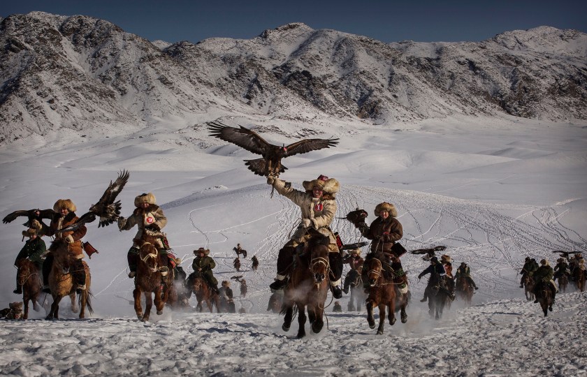 The Eagle Hunting festival, organized by the local hunting community, is part of an effort to promote and grow traditional hunting practices for new generations in the mountainous region of western China that borders Kazakhstan, Russia and Mongolia. The training and handling of the large birds of prey follows a strict set of ancient rules that Kazakh eagle hunters are preserving for future generations. (Kevin Frayer/2016 Sony World Photography Awards)