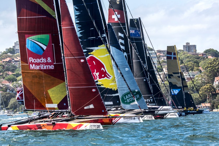 Team Australia (L) and the fleet cross the start line in their GC32 hydro-foiling catamarans during day 3 of the eighth and final act of the Extreme Sailing Series in Sydney, Australia on December 10, 2016 (Dean Treml/Red Bull Content Pool)