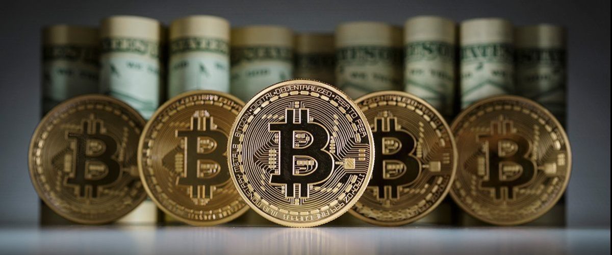 BERLIN, GERMANY - FEBRUARY 15:  In this photo illustration model Bitcoins standing in front of Dollar bills on February 15, 2016 in Berlin, Germany. (Photo Illustration by Thomas Trutschel/Photothek via Getty Images)