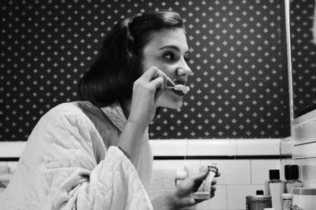 circa 1955:  A young woman brushing her teeth in her bathroom.  (Photo by Three Lions/Getty Images)