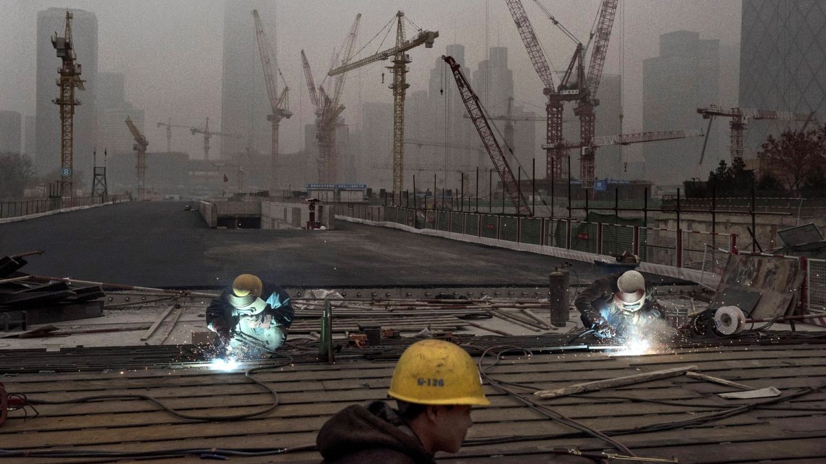 Chinese workers weld at a construction site in heavy pollution on November 29, 2014 in Beijing, China. United States President Barack Obama and China's president Xi Jinping agreed on a plan to limit carbon emissions by their countries, which are the world's two biggest polluters, at a summit in Beijing earlier this month.  (Kevin Frayer/Getty Images)