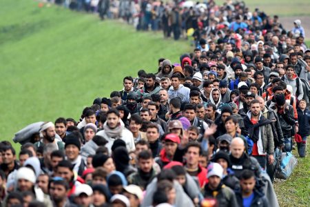 Migrants are escorted through fields by police as they are walked from the village of Rigonce to Brezice refugee camp on October 23, 2015 in Rigonce,, Slovenia. Thousands of migrants marched across the border between Croatia into Slovenia as authorities intensify their efforts to attempt to cope with Europe's largest migration of people since World War II.  (Jeff J Mitchell/Getty Images)