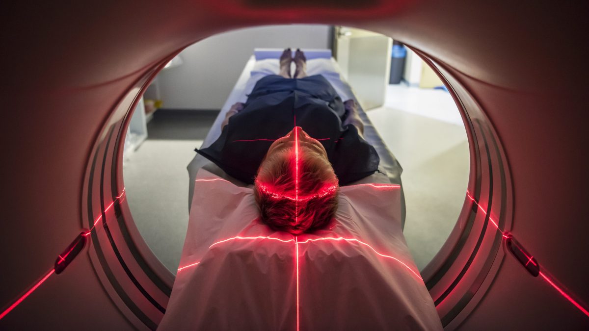 Person undergoing a CAT scan in hospital. PET scan equipment. (Getty Images)