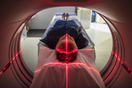Person undergoing a CAT scan in hospital. PET scan equipment. (Getty Images)
