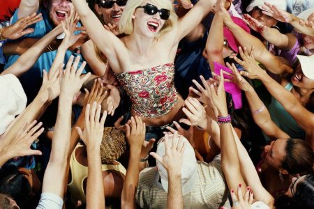 Young adults reaching for female celebrity, elevated view (Getty Images)