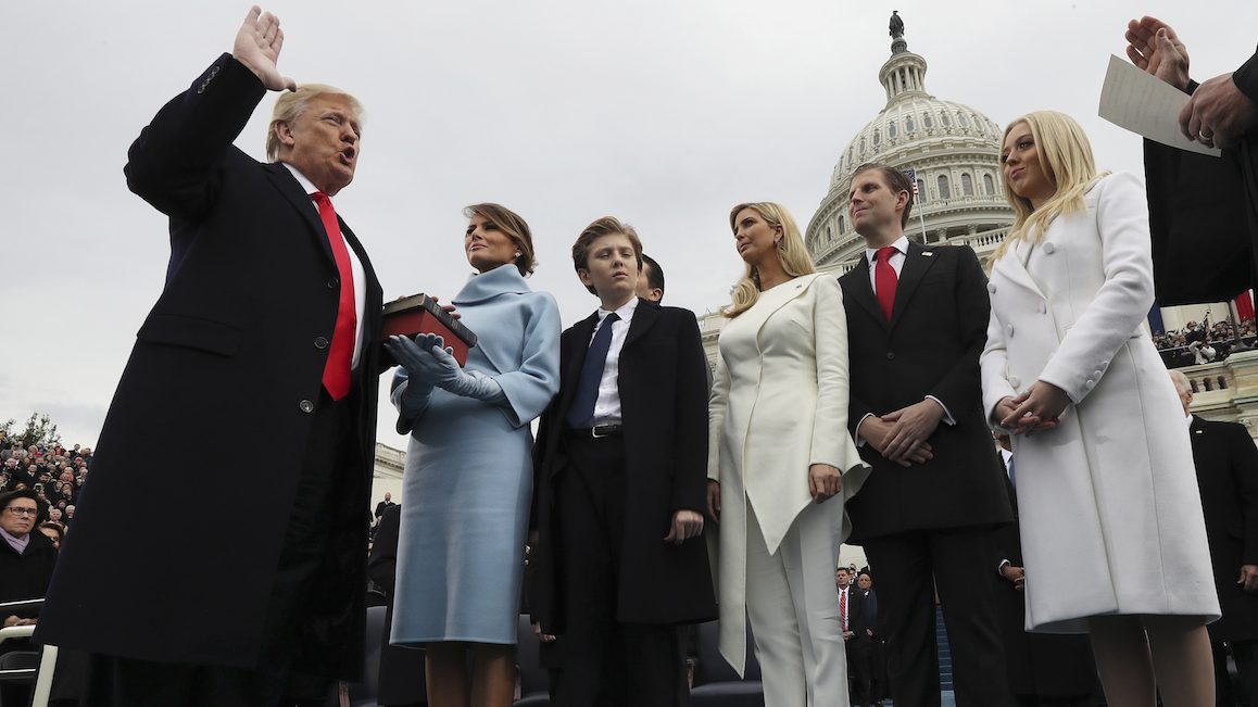 U.S. President-elect Donald Trump, left, takes the oath of office as U.S. First Lady-elect Melania Trump stands the 58th presidential inauguration in Washington, D.C., U.S., on Friday, Jan. 20, 2017. Donald Trump will become the 45th president of the United States today, in a celebration of American unity for a country that is anything but unified. Photographer: Jim Bourg/Pool via Bloomberg