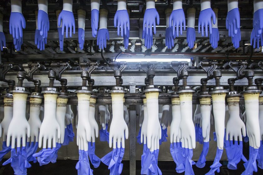 Latex gloves on hand-shaped molds move along an automated system on the production line at a Top Glove Corp. factory in Setia Alam, Selangor, Malaysia, on Thursday, Dec. 3, 2015. Top Glove, the world's biggest rubber-glove maker commanding over a quarter of the market, expects to conclude at least one acquisition in the fiscal year through August as the Malaysian company seeks to maintain record earnings momentum. (Charles Pertwee/Bloomberg via Getty Images)