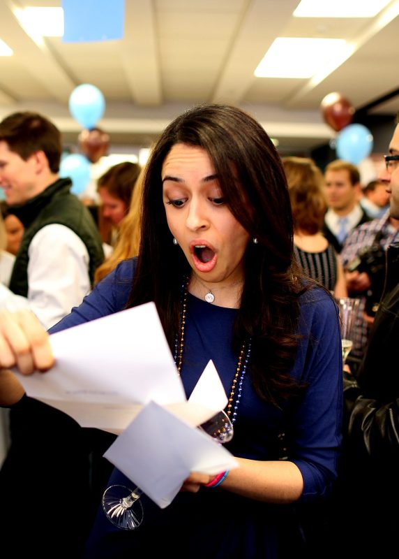 Fourth year medical students from Tufts University School of Medicine gather for what's known as Match Day to receive their envelopes telling them where they will do their residency training. Mina Khorashadi opens her acceptance letter, telling her she will be going to Stewart Carney Hospital for a one-year internship before moving to Anesthesiology at the University of California San Francisco. (Jonathan Wiggs/The Boston Globe via Getty Images)