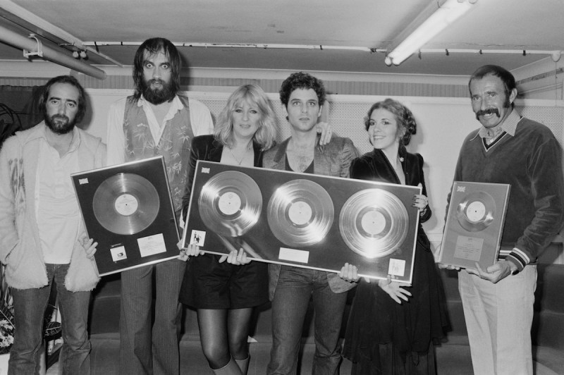 Anglo-American rock group Fleetwood Mac with awards for British sales of their albums 'Rumours' and Tusk', Wembley Arena, London, June 1980. The band are backstage at one of six shows between 20th - 27th June. Left to right: John McVie, Mick Fleetwood, Christine McVie, Lindsey Buckingham and Stevie Nicks. (Photo by Michael Putland/Getty Images)