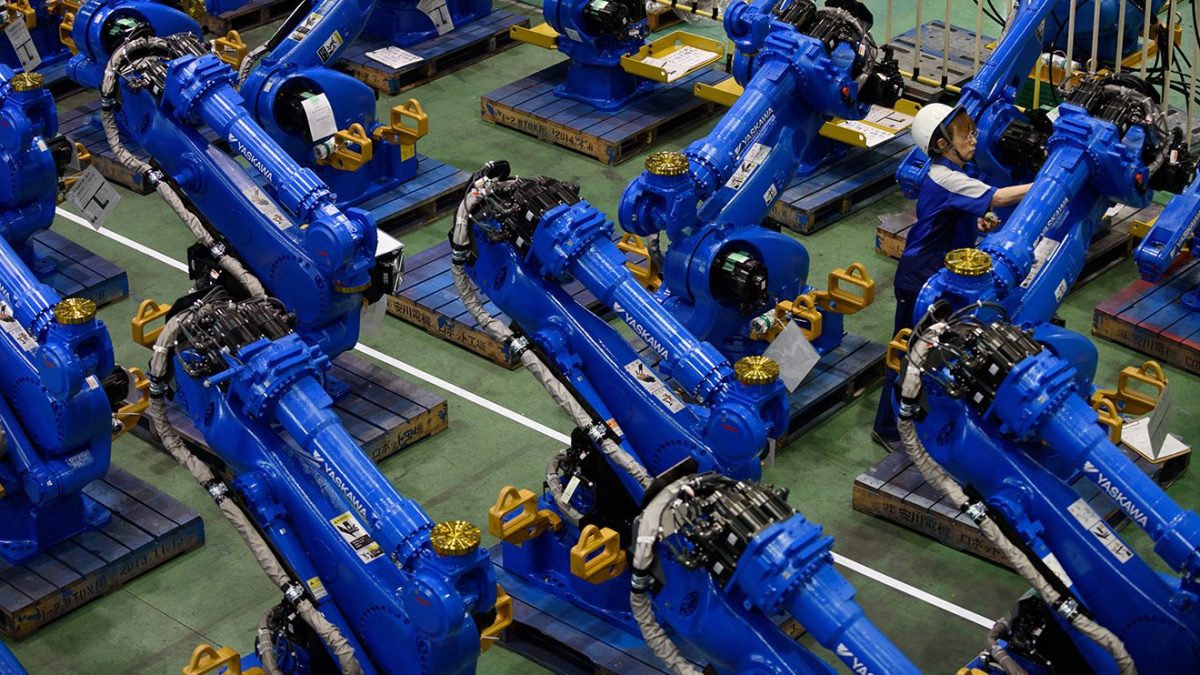 An employee inspects Yaskawa Electric Corp. Motoman robots bound for shipment at the company's factory in Kitakyushu, Japan, on Thursday, July 16, 2015. (Akio Kon/ Bloomberg)