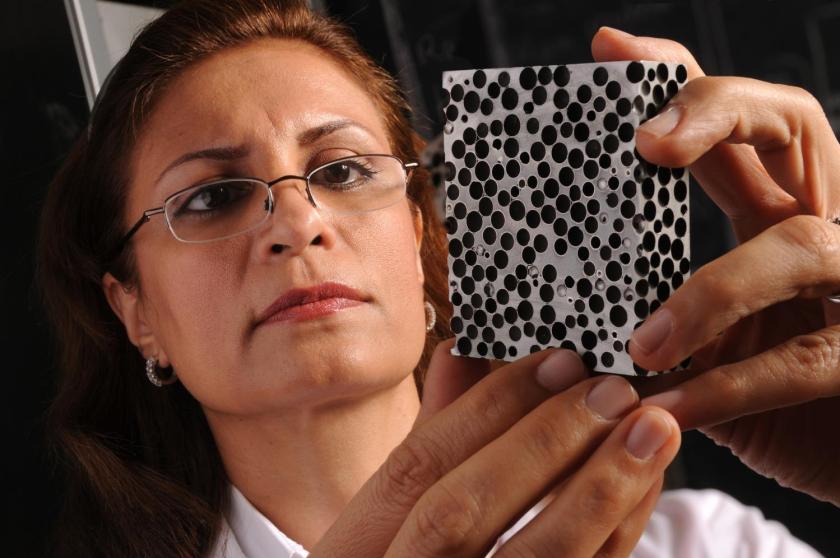 Afsaneh Rabiei examines a sample of metal foam. A new study by Rabiei finds that novel light-weight composite metal foams are significantly more effective at insulating against high heat than the conventional base metals and alloys that they're made of, such as steel. The finding means the CMF is especially promising for use in storing and transporting nuclear material, hazardous materials, explosives and other heat-sensitive materials, as well as for space exploration. (North Carolina State University)