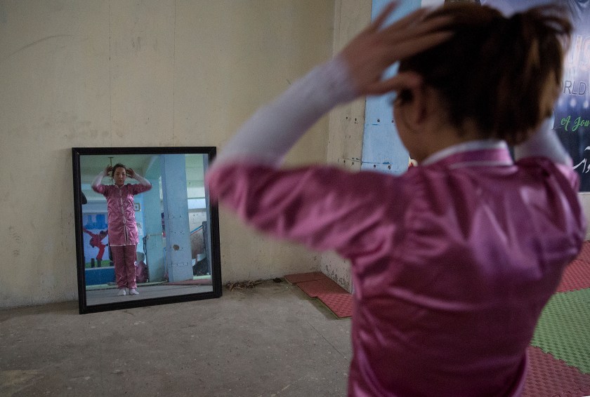 A Shaolin martial arts student prepares to practice at her club in Kabul, Afghanistan, Tuesday, Jan. 25, 2017. At first the women could not find Shaolin uniforms, but, undeterred, they designed and ordered uniforms made by a Kabul tailor. (AP Photos/Massoud Hossaini)