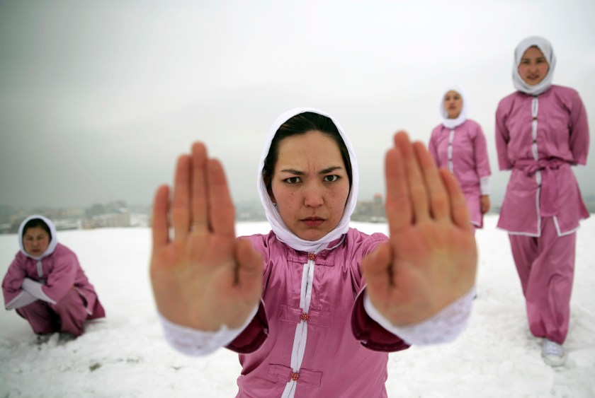 Shaolin martial arts students practice on a hilltop in Kabul, Afghanistan, Tuesday, Jan. 25, 2017. Teacher Sima Azimi, 20, not pictured, who is originally from Jaghuri in central Afghanistan, trains nine students in the martial arts to prepare for Olympic competitions, but also to protect themselves on the streets of Kabul, where women are routinely harassed. (AP Photos/Massoud Hossaini)