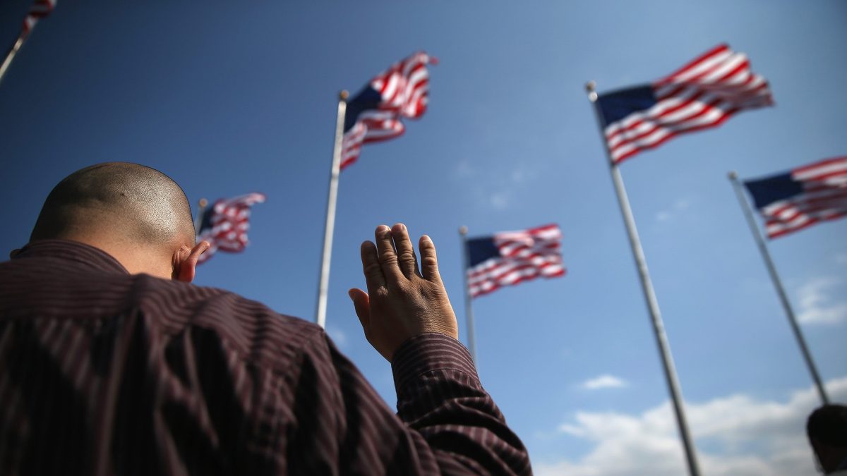 Immigrants take the oath of citizenship to the United States during a naturalization ceremony at Liberty State Park on September 19, 2014 in Jersey City, New Jersey. (John Moore/Getty Images)